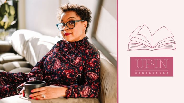 A graphic that has a photo of Dr. Jane Jones, a black woman, with a cup of coffee sitting on her sofa, looking at the camera. She is wearing a paisley dress and glasses. Also on the graphic is an icon of a book, and the Up In Consulting logo, Jane's business.