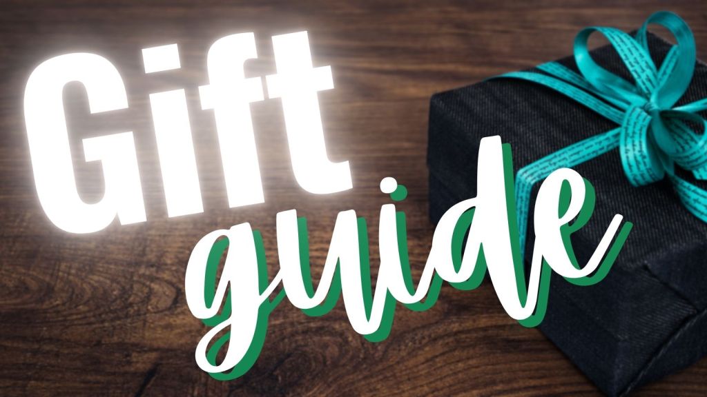 Gift guide for academics 2022: a wrapped present with a teal bow sits on a table.