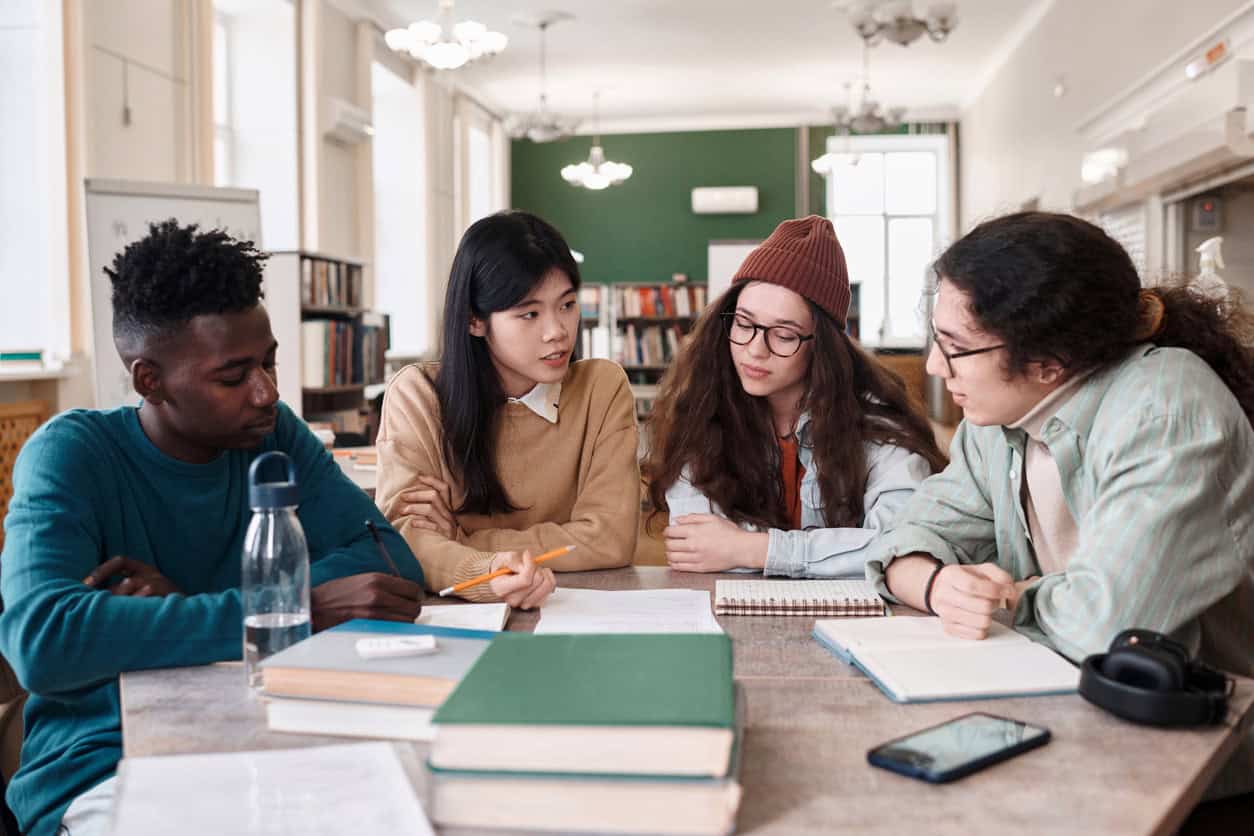 Group of international students at desk.