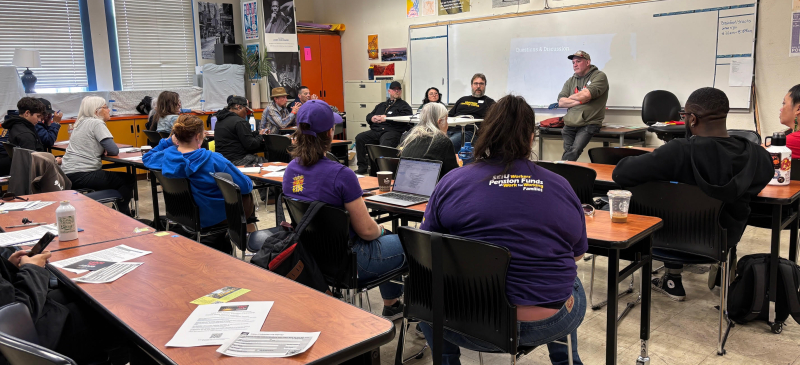 Workers gathered in a classroom.