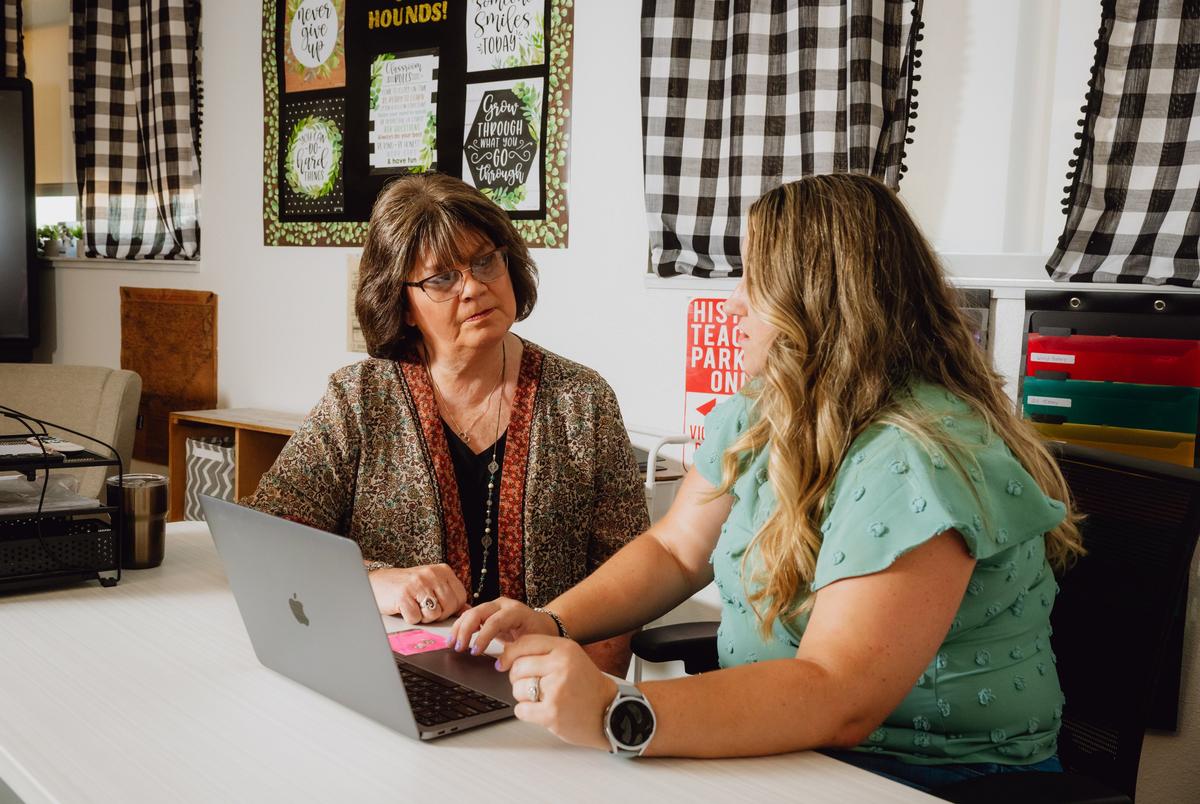 THROCKMORTON, TEXAS — JULY 29, 2025: Gay Hibbitts, 57, educator, left, speaks with her mentor, Amy Dick, 34, secondary social studies teacher at Throckmorton Collegiate ISD,  inside a classroom at Throckmorton Collegiate ISD in Throckmorton, Texas, on Tuesday, July 29, 2025. Ms. Hibbitts was part of a federally funded educator preparation program serving about 30 participants across 11 rural Texas districts. The funding, which covered two years of college and training costs, was cut on April 25 under the Trump and Elon Musk DOGE initiative, leaving her uncertain about her future. She is pursuing a bachelor’s degree in general studies with an emphasis in education and a minor in psychology at West Texas A&M. CREDIT: Desiree Rios for The Texas Tribune