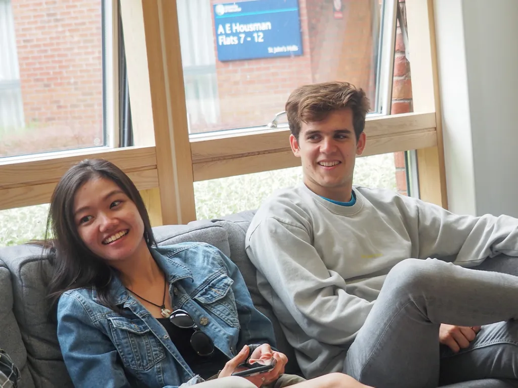 Two students on a sofa