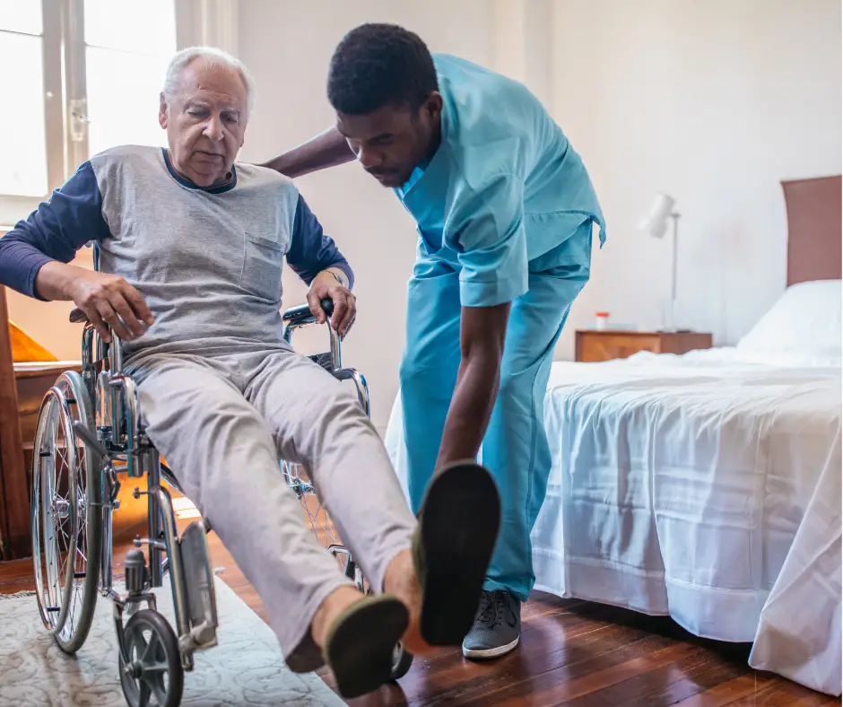 Male, African American nurse assists a patient in a wheelchair